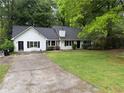 One-story home with white siding, a dark roof, green lawn and driveway at 3013 Barcelona Way, Conyers, GA 30012