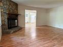Cozy living room featuring hardwood floors and a stunning stone fireplace at 3013 Barcelona Way, Conyers, GA 30012