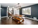 Dining room featuring a custom dining table with bench seating and modern lighting fixture at 1828 Kellogg Creek Rd, Acworth, GA 30102