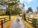Long, gated driveway leading to a rustic outbuilding on a lush, green property at 1828 Kellogg Creek Rd, Acworth, GA 30102