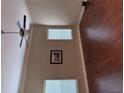 Cozy living room with tall ceilings, two large windows, a ceiling fan, and hardwood flooring at 3622 Foxtrot Nw Trl, Kennesaw, GA 30144