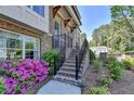 Brick steps leading to the entrance, framed by vibrant flowers and lush greenery at 4007 Dunwoody Trce, Atlanta, GA 30338