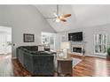 Comfortable living room with fireplace, hardwood floors, a ceiling fan and plenty of space for Gathering and friends at 5845 Shannon Dr, Cumming, GA 30040