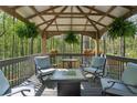 Inviting covered patio with comfortable seating, perfect for outdoor relaxation and enjoying the surrounding nature at 5845 Shannon Dr, Cumming, GA 30040