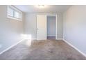 Cozy bedroom with neutral carpet, light gray walls, and natural light from the window at 3905 Kirksford Dr, Decatur, GA 30035