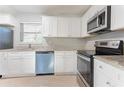 Bright kitchen features white cabinets, granite countertops, and stainless steel appliances at 3905 Kirksford Dr, Decatur, GA 30035