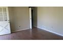 A clean bedroom with laminate floors and a standard door to hallway or closet at 8317 Marlborough Dr, Jonesboro, GA 30238