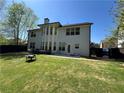 Large, level backyard with a dark wood privacy fence, a patio, and plenty of green space at 2964 Olivine Dr, Dacula, GA 30019