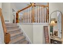 Carpeted staircase with wood railing leads to the upper level, accented by a welcome sign at 4917 Baker Ridge Pl, Acworth, GA 30101