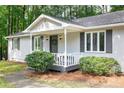 Charming front porch with seating area and neatly landscaped shrubbery, offering curb appeal at 5819 Stonehaven Nw Dr, Kennesaw, GA 30152