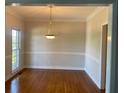 Traditional dining room boasts hardwood floors, decorative molding, and an elegant chandelier at 8100 Greens Mill Way, Loganville, GA 30052