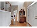 Welcoming entryway featuring hardwood floors, a staircase, and a stylish accent table at 8100 Greens Mill Way, Loganville, GA 30052