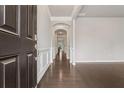 Inviting hallway features hardwood floors, archways, fresh paint and decorative wall trim at 104 Marlow Dr, Woodstock, GA 30188