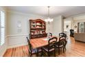 Formal dining room with hardwood floors, wainscoting, and elegant chandelier at 1058 Magnolia Dr, Villa Rica, GA 30180