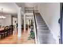 Bright foyer featuring hardwood floors, a staircase with iron railings, and an open view to living spaces at 1058 Magnolia Dr, Villa Rica, GA 30180