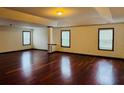 Large bonus room with hardwood flooring and neutral walls, perfect for entertaining at 5589 Dendy Trc, Fairburn, GA 30213