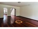 Spacious living room showcasing hardwood floors and a distinctive starburst inlay design at 5589 Dendy Trc, Fairburn, GA 30213