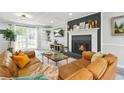 Cozy living room featuring a fireplace, built-in shelving, and large windows for natural light at 750 Southland Pass, Stone Mountain, GA 30087