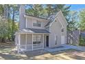 Attractive two-story home featuring a covered porch, neutral gray siding, and an attached one-car garage at 772 Edenton Ct, Jonesboro, GA 30238