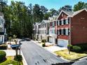 View of brick townhomes on a tree-lined street at 2928 Wintercrest Way, Atlanta, GA 30360