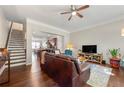 Open-concept living room features hardwood floors, a ceiling fan, and seamless flow to the kitchen area at 1647 Sabastian Ne Pt, Atlanta, GA 30329