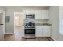 Modern kitchen with stainless steel appliances, granite countertops, and hardwood floors for a clean and stylish look at 2240 Polar Rock Sw Ave, Atlanta, GA 30315
