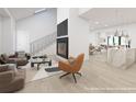 Open-concept living area featuring modern decor, a fireplace, and seamless access to dining and kitchen spaces at 3353 Hemphill St, Atlanta, GA 30337