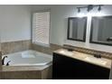 Bright bathroom with a corner soaking tub, double vanity, and tile accents at 615 Old Johnson Rd, Lawrenceville, GA 30045
