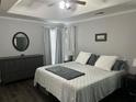 Comfortable bedroom features tray ceiling, neutral color scheme, and generous natural light at 615 Old Johnson Rd, Lawrenceville, GA 30045