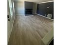 Bright living room with fireplace and light, wood-look flooring at 912 Holden Ln, Atlanta, GA 30349