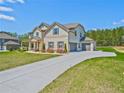 Spacious home featuring a three-car garage and long driveway at 125 Leverett Ct, Fayetteville, GA 30215