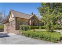 A home with brick and light siding, complemented by stone wall and vibrant landscaping at 1285 Oakdale Ne Rd, Atlanta, GA 30307