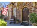 Brick house featuring a wooden front door, rocking chair, and American flag at 1285 Oakdale Ne Rd, Atlanta, GA 30307