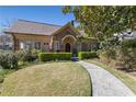 Inviting brick home with manicured hedges, lush lawn, and a curved walkway at 1285 Oakdale Ne Rd, Atlanta, GA 30307