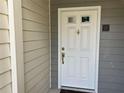 The front door of the home is white with a gold door handle at 25 Fair Haven Way, Smyrna, GA 30080