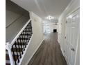 Spacious entryway with hardwood floors, staircase, and view of a living room with a fireplace at 3131 Leyland Ct, Decatur, GA 30034