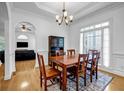 Elegant dining room with hardwood floors, wainscoting, a chandelier, and ample natural light at 416 Wilfawn Way, Avondale Estates, GA 30002