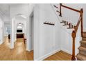 Bright hallway featuring hardwood floors, a staircase with wooden banister, and access to other rooms at 416 Wilfawn Way, Avondale Estates, GA 30002