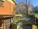 Backyard area of home featuring patio with decorative ironwork and some trees at 2019 Thomasville Se Dr, Atlanta, GA 30315
