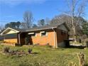 Cozy brick home featuring an enclosed porch area and a compact backyard at 2019 Thomasville Se Dr, Atlanta, GA 30315