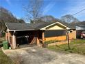 Brick house with a gated entrance and attached carport on a sunny day at 2019 Thomasville Se Dr, Atlanta, GA 30315