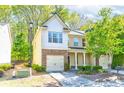 Charming two-story home with a mix of siding and stone, two-car garage and manicured landscaping at 2904 Ridgeview Sw Dr, Atlanta, GA 30331