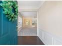 Open foyer showcasing hardwood floors and wainscoting, leading into a bright and airy living space at 3915 Deerborne Dr, Cumming, GA 30040