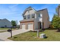 Beautiful two-story home with a brick and siding exterior, two-car garage, and manicured front yard at 5620 Weddington Drive Dr, Cumming, GA 30040
