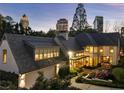 A view of the backyard of a well-kept home with lush green landscaping with the city skyline in the background at 123 Peachtree Cir, Atlanta, GA 30309