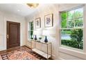 Elegant foyer featuring a stylish console table with lamps, beautiful rug, and natural light streaming through large windows at 123 Peachtree Cir, Atlanta, GA 30309