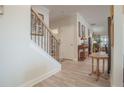 Bright and spacious hallway featuring hardwood floors, a staircase, and tasteful decorations along the walls at 15 Masters Dr, Villa Rica, GA 30180