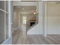 Welcoming entryway with wood-look floors, staircase, and bright, neutral decor at 21 Homesite Cooper E Cv, Fayetteville, GA 30215