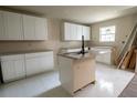 New kitchen featuring white cabinets, countertops, an island, and stainless steel sink at 2191 Camp Ground Rd, Atlanta, GA 30331
