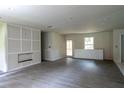 Open concept living room with grey flooring, featuring an unfinished fireplace at 2191 Camp Ground Rd, Atlanta, GA 30331